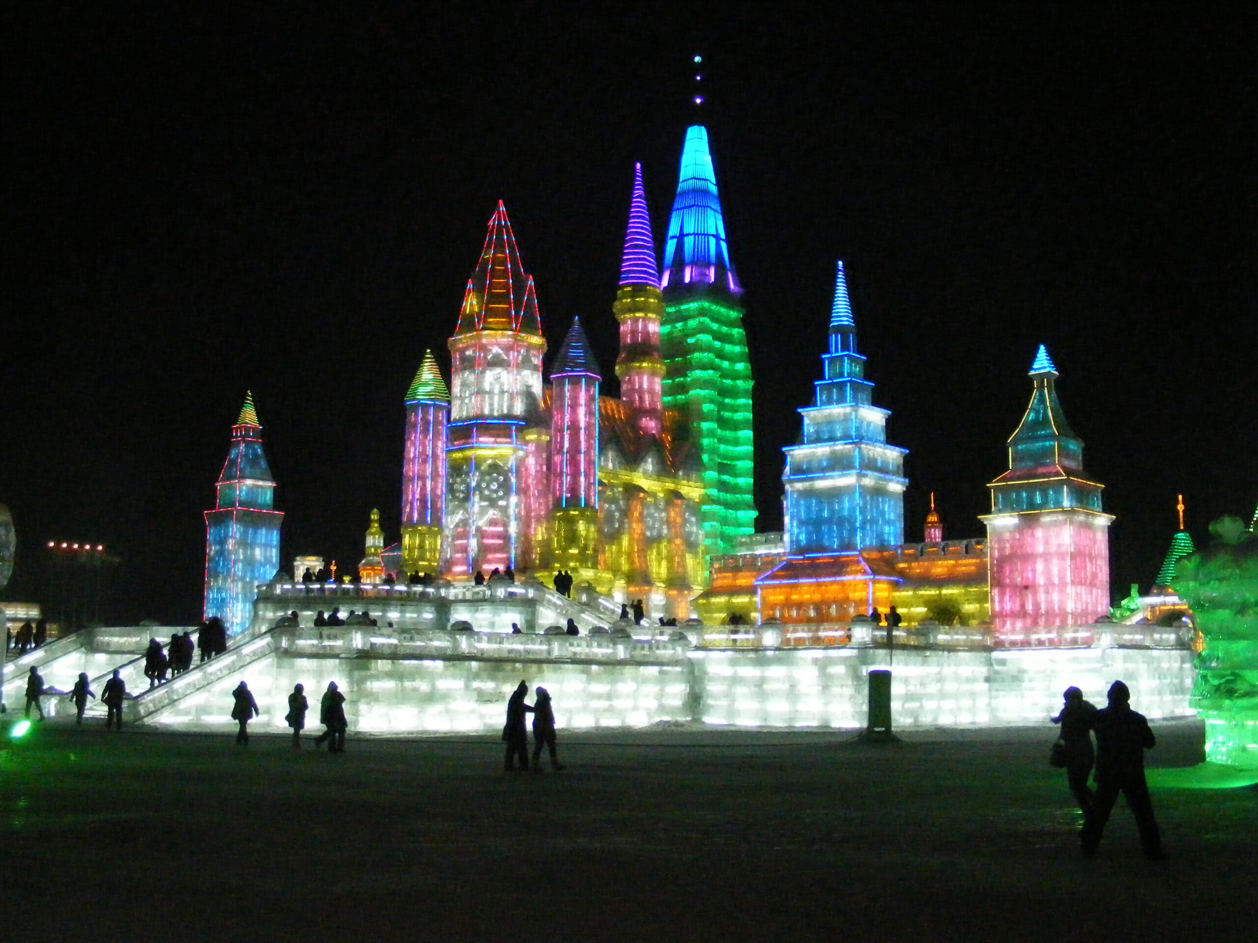 Illuminated ice buildings at Harbin's Ice and Snow World festival at night