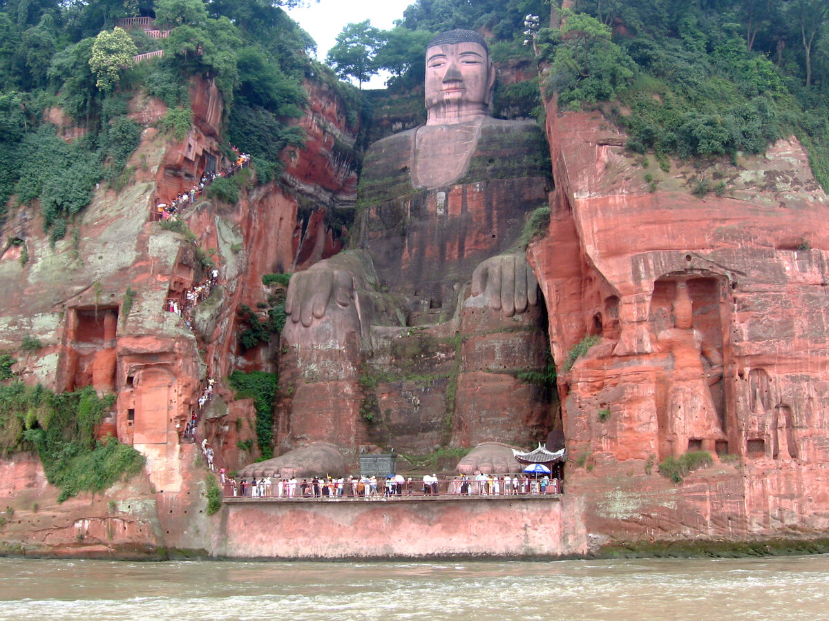 Full view of the Leshan Giant Buddha carved into the red sandstone cliff